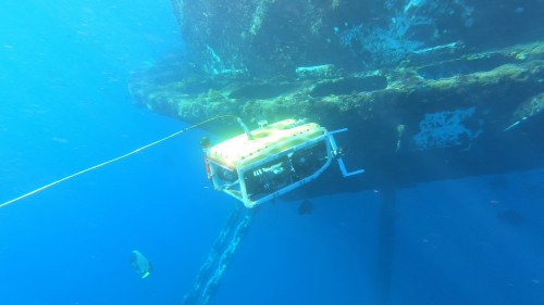 A rope access hull tank inspector conducting marine class inspections on an FPSO tank offshore