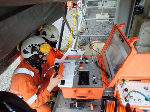 Two vertech RDVI technicians controlling a crawler robotic via an electronic case with a screen.