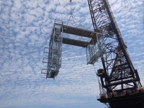 An image of APS modular scaffolding that had been pre erected being lifting into place on the Gorgon LNG construction project