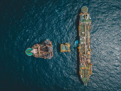Bird's Eye view shot of an FPSO and Rig with a helicopter landing pad on top.