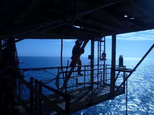 A vertech technician is carrying out work on the underside of the Chevril platform as part of a decommissioning service.