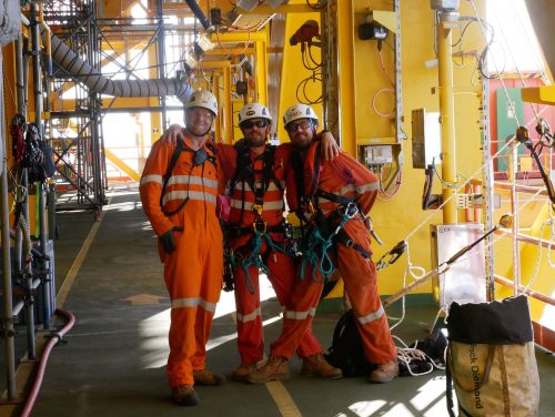 Vertech technicians stop and pose for a photo onboard an fpso.loading=