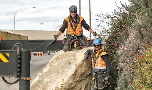 A rope access geotechnical team removing boulders to make roads and rail ways safe