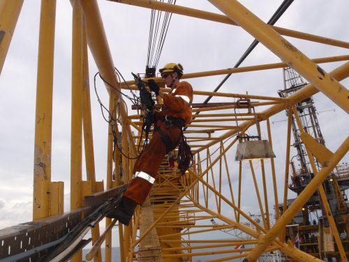 A Vertech IRATA lifting and NDT inspector conducting Ultrasonic testing on a crane boom