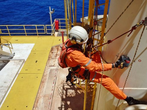 A vertech IRATA rope access technician is carrying out NDT on a support beam onboard an FPSO.