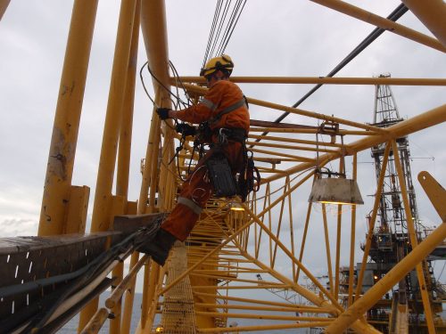 a Vertech IRATA rope access technician is working on the inside of a crane arm.