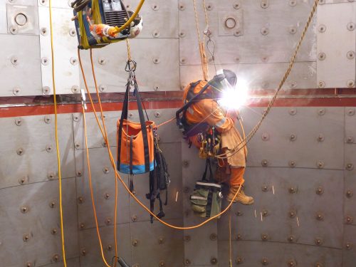 Vertech rope access technicians conducting weld repairs from ropes on an LNG facility under construction