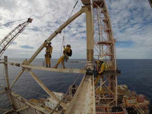 Three Vertech IRATA Rope Access technicians perform work on a derrick as part of a decommissioning service.