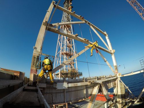 An underside shot of two Vertech IRATA rope access technicians performing duties as part of a derrick decommissioning service.