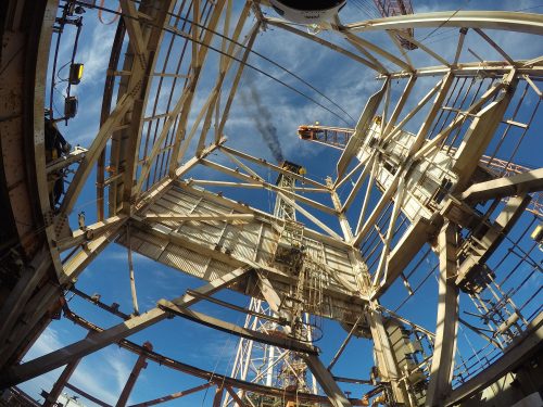 A shot from beneath a derrick looking upwards shows the process of decommissioning.