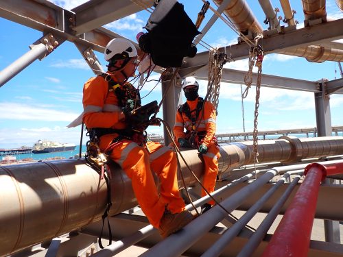 A vertech AICIP and NDT team conducting tablet based inspections in a pipe rack in the pilbara region.loading=