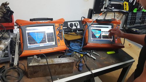 Two Non-Destructive testing kits are displayed on a workbench.loading=