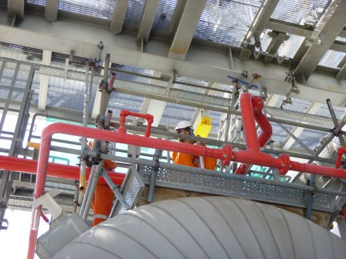 An underside shot of a vertech technician carrying out a testing procedure.