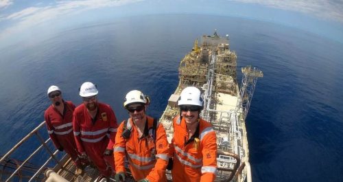 Three Vertech technicians taking a selfie on top of the FPSO.
