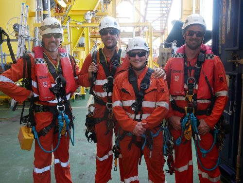 A group photo of vertech technicians posing onboard the fpso.