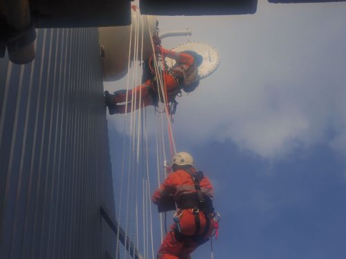 Two Vertech IRATA Rope Access Technicians are suspended on the side of the Ichthys Venturer FPSO.loading=