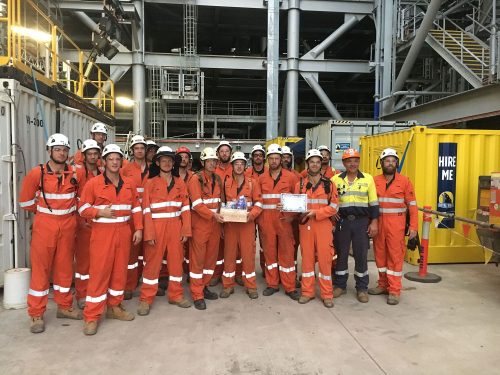 The vertech team poses a photo in front of the INPEX LNG plant.