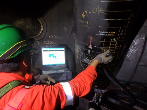 An NDT inspector taking ultrasonic readings as part of a marine class project on a riser turret mooring (RTM) of an FPSO offshore
