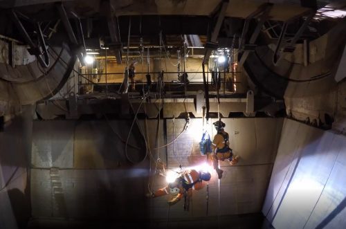 Vertech rope access welders conducting wear liner plate replacements on a Train Load out bin (TLO) at a western australian iron ore mine