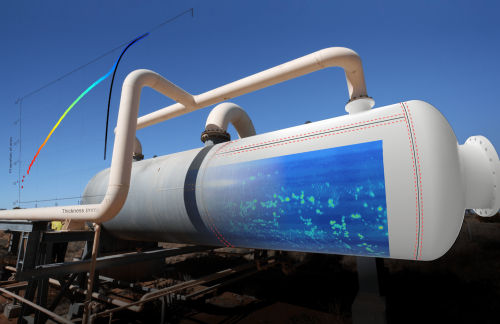 This composite image features a large industrial pipe system in a desert setting juxtaposed with a section of a corrosion mapping graphic. A graph overlay indicates the relationship between pipe thickness and corrosion rate, with coloured lines representing different rates. The visual metaphor suggests the importance of pipe thickness in preventing corrosion, likely in the context of oil and gas industry infrastructure.
