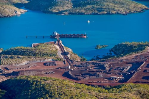 A colour photograph of a mining pit with a path running out to a jetty on the water on Koolan Island, taken in the 1990s.