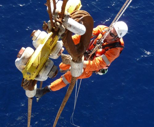 Vertech lifting engineers completing an over water inspection of lifting slings via rope access.