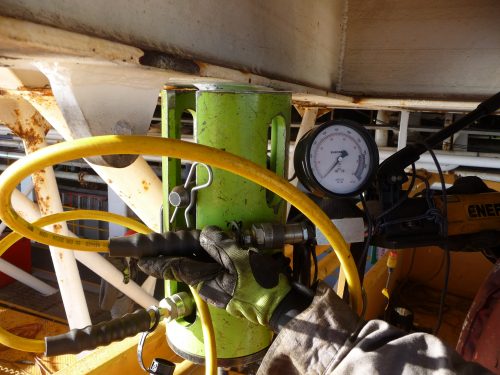 A green monster pad eye tester conducting proof load testing as part of a lifting equipment inspection and recertification campaign