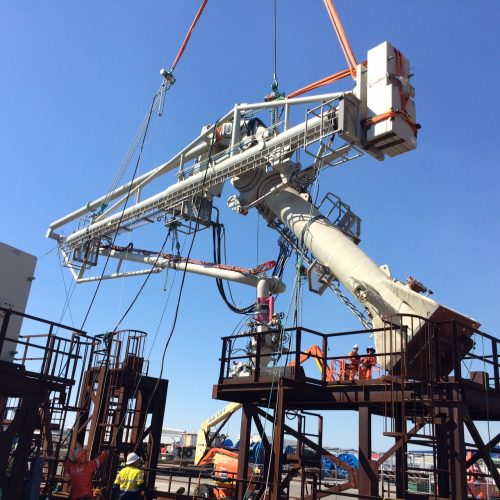 The marine loading arm hoisted upwards as part of the installation process.