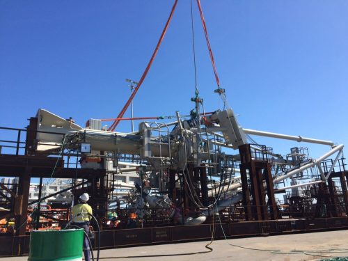 A technician looks on as the marine loading arm is prepped for installation.