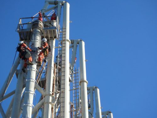 Two vertech IRATA rope access technicians scale the structure of the KGP Facility.