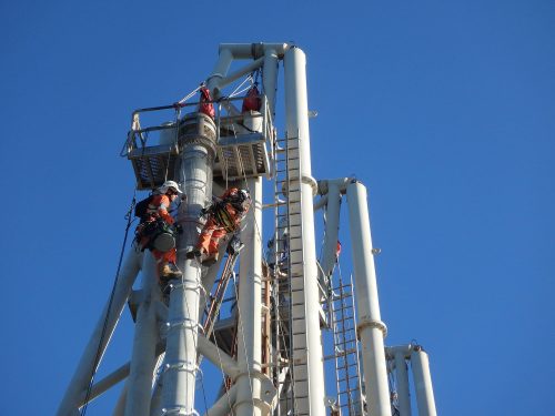 Two vertech IRATA rope access technicians scale the structure of the KGP Facility.