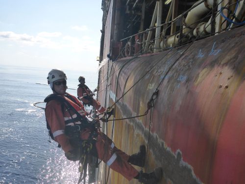 A Vertech rope access marine inspector takes NDT and ultrasonic thickness readings on an FPSO hull.