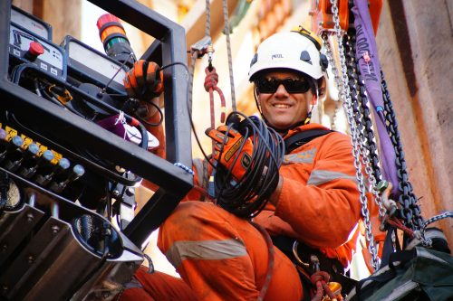 A Vertech technician smiles for the camera while working on a decommissioning job.