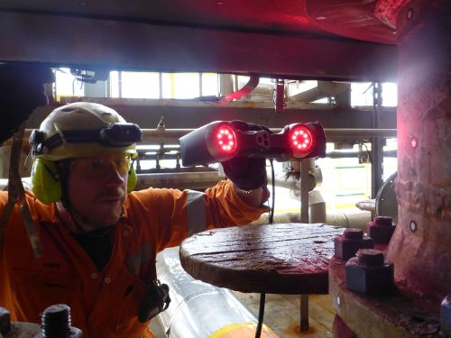 A vertech technician is conducting an NDT using a light-based system.