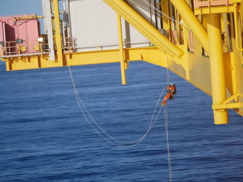 A Vertech IRATA Rope Access Technician hangs suspended on the underside of the CPF.