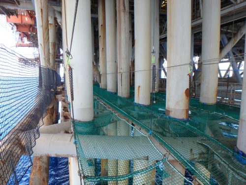 An image of tension netting installed by Vertech IRATA rope access technicians around the caissons of an offshore platform so that maintenance and inspection can be conducted safely.