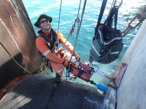 A Vertech IRATA Rope access Tradesman conducting core drilling via overwater rope access.