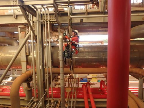 A vertech IRATA rope access technician inspects plant infrastructure as part of a broader baseline test.