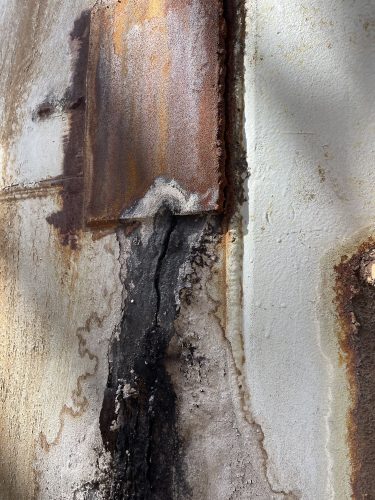 A close-up image showing some damage to refinery equipment.