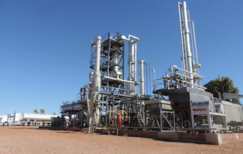 Field of view shot of an oil refinery with desert scenery.