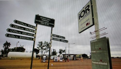 A sign at an outback service station in the town of Eromanga. The distances to each state's capital city is listed on several signs.