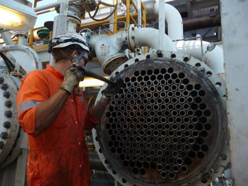 An inspector checking tube bundles before IRIS tube inspection.