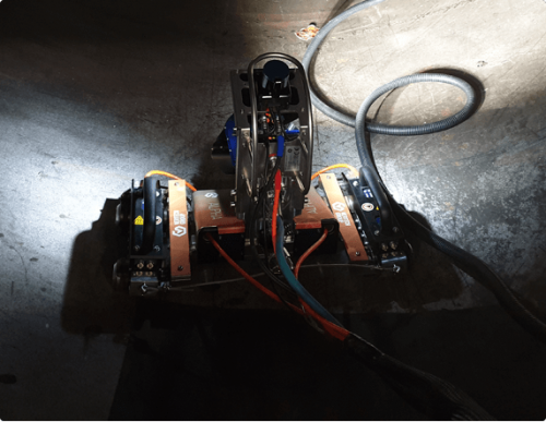 A robotic crawler system conducting Remote visual inspection of a pressure vessel