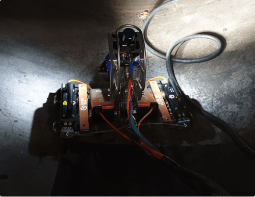 A robotic crawler system conducts a remote visual inspection of a pressure vessel.