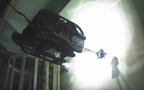 An ROV is inspecting a tank wall.