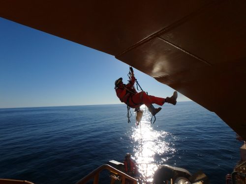 A vertech IRATA rope access technician hangs suspended on the underside of the RTM.