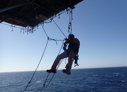 access management: A Vertech IRATA rope access technician conducting helideck inspections offshore
