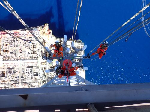 Three Multi skilled IRATA rope access tradesmen completing a flare tip replacement on an offshore FPSO in Australia