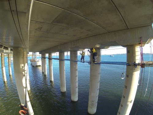 The underside of the Gladstone LNG facility's tension netting being installed by two Vertech IRATA rope access technicians.loading=