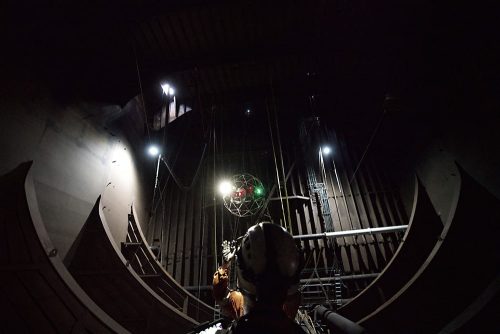 A vertech technician is flying a drone with an electronic device.